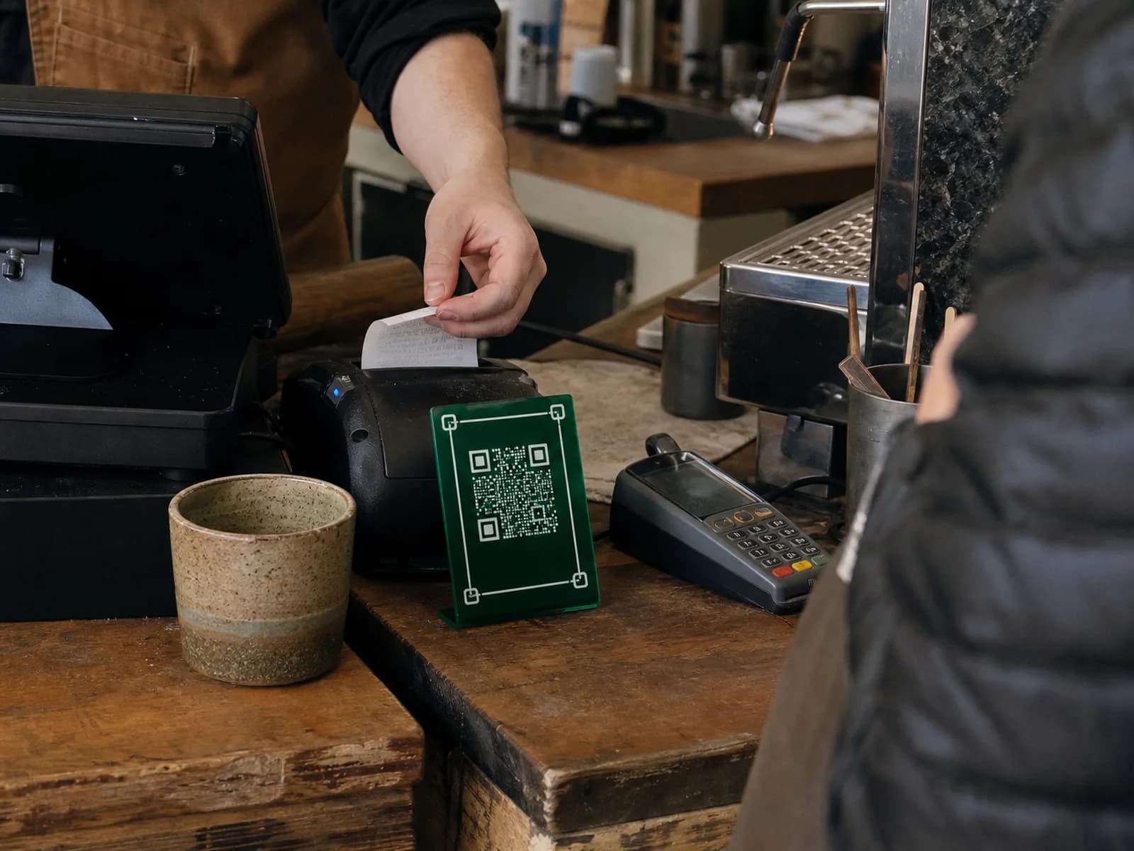 A Coco Card standee sitting beside the till on a shop counter